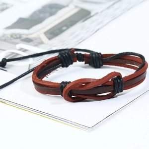 Close-up of brown and black braided leather bracelet with adjustable knot detailing