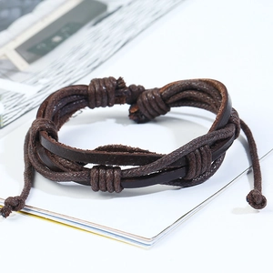 Detail of multi-layer braided brown leather bracelet with twisted rope and knotted design