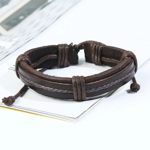 Detail view of a multi-layer dark brown leather bracelet with braided rope and knot design