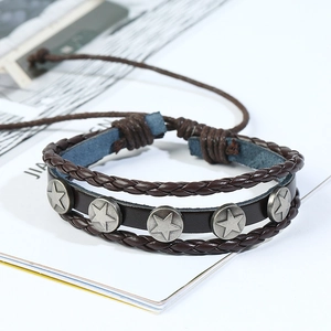 Detail of brown multilayer leather bracelet with metal star studs and woven edges