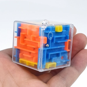 Close-up of portable 3D cube maze puzzle with colorful inner tracks and steel ball
