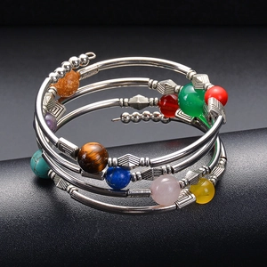 Detailed close-up of multilayered spiral bracelet featuring colorful semi-precious beads