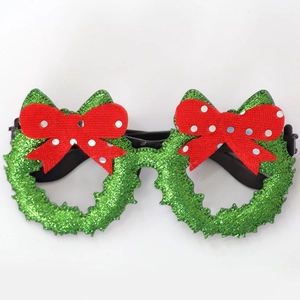 Detail of glittery green wreath Christmas glasses with red bows and sequins for parties