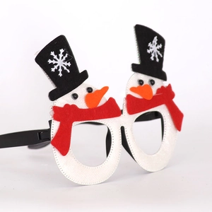 Detail of Christmas snowman party glasses featuring glitter texture and carrot nose