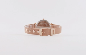 Detail of rose gold mesh watch strap and stainless steel case back with engraving