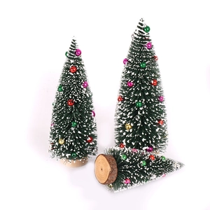 Set of three mini flocked Christmas trees with colorful beads and natural wood bases