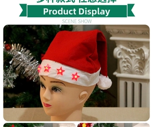 Detail of red plush Santa hat with four glowing red star ornaments on white brim