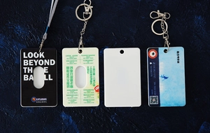 Detail showing various ABS plastic card holders with metal rings and fabric lanyards