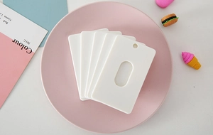 Macro detail of white ABS plastic ID card holder with round hole and oval cutout
