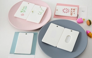 Detail of white DIY ABS plastic card holders with round holes for student IDs