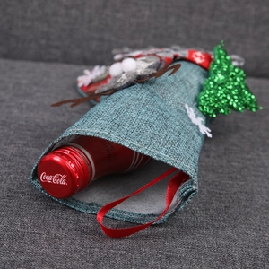 Close-up of a blue knitted Christmas stocking with reindeer and sequin tree embroidery