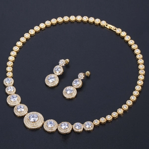 Detailed view of gold bridal jewelry set featuring shimmering round micro-pave crystals