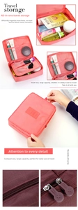 Detail view of pink travel toiletry bag with multiple mesh pockets and brush organizers