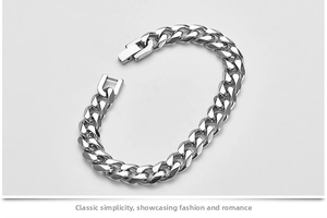 Detailed macro view of the polished silver Cuban link chain and fold-over clasp