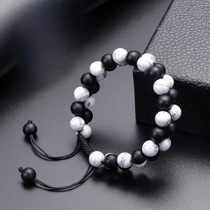 Close-up of matte black agate and white turquoise beads on double-layered bracelet