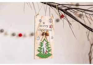 Close-up of wooden Merry Christmas hanging sign with pine cone and reindeer forest detail