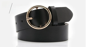 Close-up of black leather belt featuring a polished golden round metal buckle