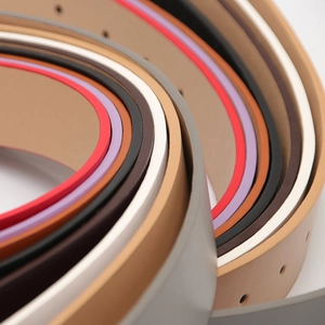 Women's minimalist leather belts with round buckles in various vibrant colors