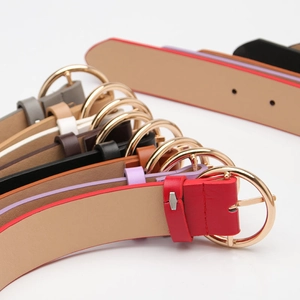 Variety of colorful minimalist faux leather belts with elegant golden round metal buckles