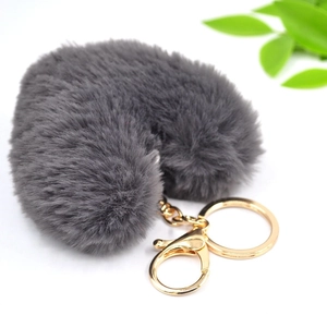 Detailed view of heart-shaped dark grey faux fur keychain with gold-tone lobster clasp