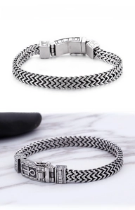 Close-up of double-row woven chain bracelet with antique silver finish and cross clasp