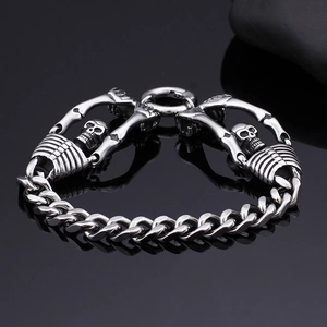 Punk style men's titanium steel bracelet featuring detailed silver skull and flat curb chain