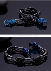 Detailed macro view of 316L stainless steel skull bracelet with cross and blue charms