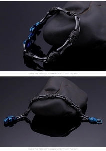 Close-up of punk skull cross bracelet in black and blue stainless steel finish