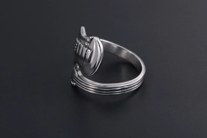 Detailed view of silver guitar ring showing intricate headstock and fretboard textures