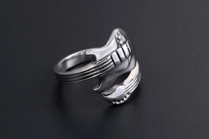 Detailed close-up of a vintage silver guitar-shaped adjustable open ring in titanium steel