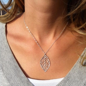 Elegant silver leaf pendant necklace for women worn on neck in a minimalist style