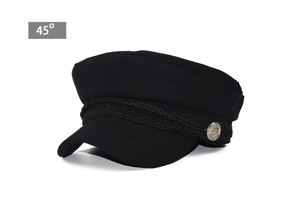 Detail of black military octagonal hat featuring a vintage gold anchor button at 45 degree