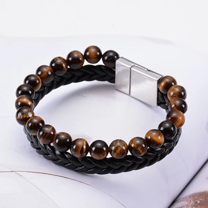 Detailed shot of men's double-row bracelet with tiger eye stones and black braided leather