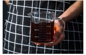 Detail view of 300ml heat-resistant borosilicate glass measuring cup with clear white scales