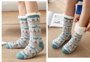 Detail of fleece-lined thermal socks with Christmas reindeer pattern and fluffy white cuffs