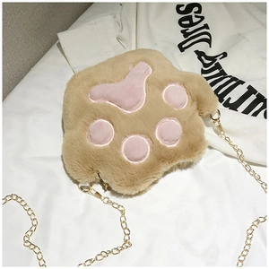 Close-up of plush cat paw crossbody bag with pink pads and gold metal chain