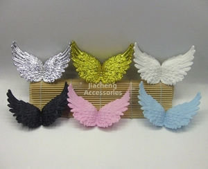 Detail showing various colors of plastic angel wings for Christmas cake decoration