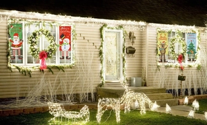 Outdoor Christmas banners with Santa Claus and snowman patterns on house window sides