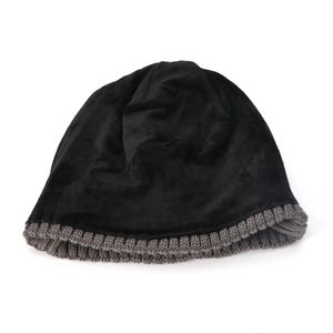 Detailed close-up of a double-layered black knitted winter hat with gray ribbed cuff texture