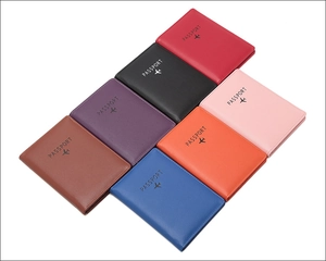 Flat lay of multi-color RFID blocking passport covers in seven vibrant textured PU leather