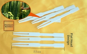 Macro detail of 88mm premium natural bamboo fruit picks with flat-head two-prong design