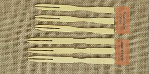 Detailed close-up of disposable bamboo fruit forks in heart and gourd handle styles