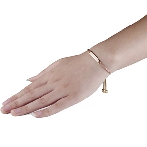 Nahaufnahme eines polierten Roségold-Stabarmbands mit verstellbarer Schiebekette und Perlen