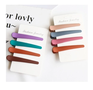 Close-up of colorful matte duckbill hair clips in eight assorted vibrant pastel colors