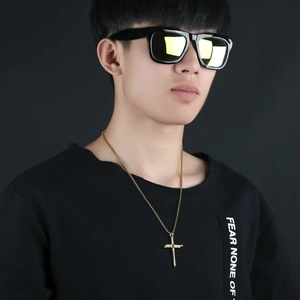 Male model wearing long gold cross pendant necklace in minimalist stainless steel style