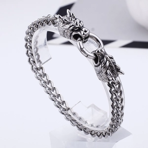 Punk style stainless steel dragon head bracelet with vintage silver finish on display stand