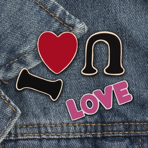 I LOVE U heart-shaped alloy enamel brooches set on blue denim fabric background
