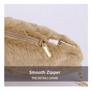 Detail of khaki faux fur bag featuring a smooth gold zipper and metallic chain strap