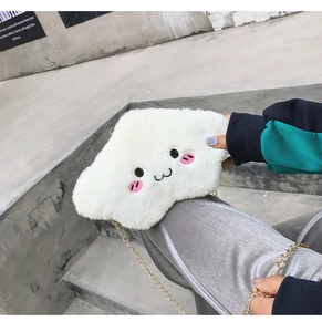 Close-up of white plush cloud bag featuring cute face embroidery and golden chain strap