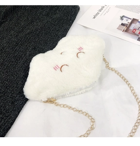 Close-up of white plush cloud bag with embroidered smiley face and gold chain strap